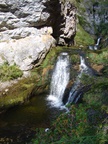 The water cascades from the water hole spring