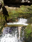 The water cascades from the water hole spring